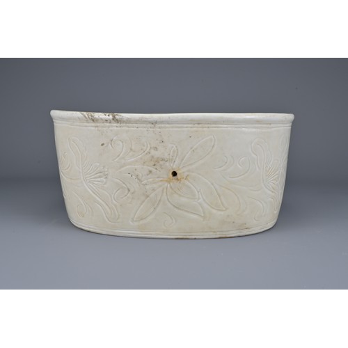 38 - A Chinese white-glazed pottery pillow with incised decoration of flowers and fish. Width approx. 24c... 