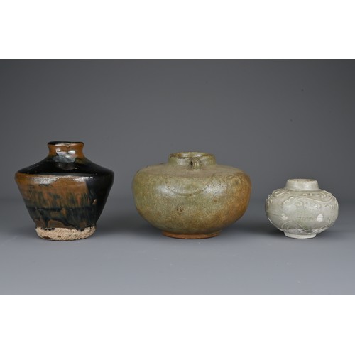 40 - Three Southeast Asian pottery jars. One covered in a black and russet glaze, the others in greyish-g... 