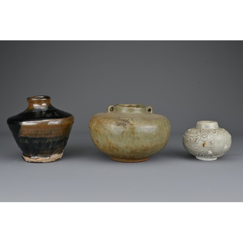 40 - Three Southeast Asian pottery jars. One covered in a black and russet glaze, the others in greyish-g... 