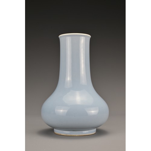 63 - A Chinese clair-de-lune-glazed porcelain vase. The Hu form vase covered in a pale blue glaze whiteni... 