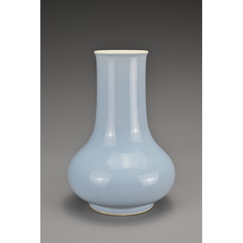 63 - A Chinese clair-de-lune-glazed porcelain vase. The Hu form vase covered in a pale blue glaze whiteni... 