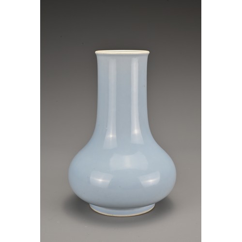 63 - A Chinese clair-de-lune-glazed porcelain vase. The Hu form vase covered in a pale blue glaze whiteni... 