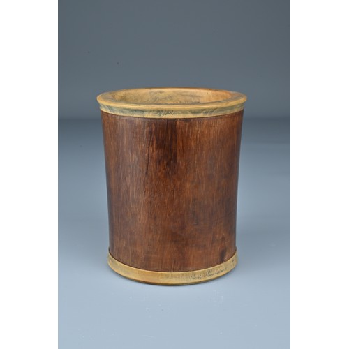 64 - A Chinese Huanghuali wood brush pot with added hardwood rim and base. Height 10.5cm. Diam. 9cm