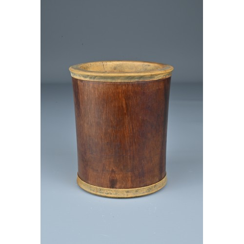 64 - A Chinese Huanghuali wood brush pot with added hardwood rim and base. Height 10.5cm. Diam. 9cm