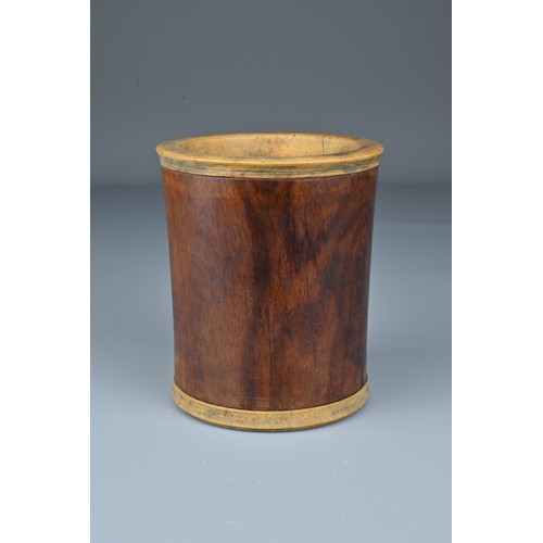 64 - A Chinese Huanghuali wood brush pot with added hardwood rim and base. Height 10.5cm. Diam. 9cm