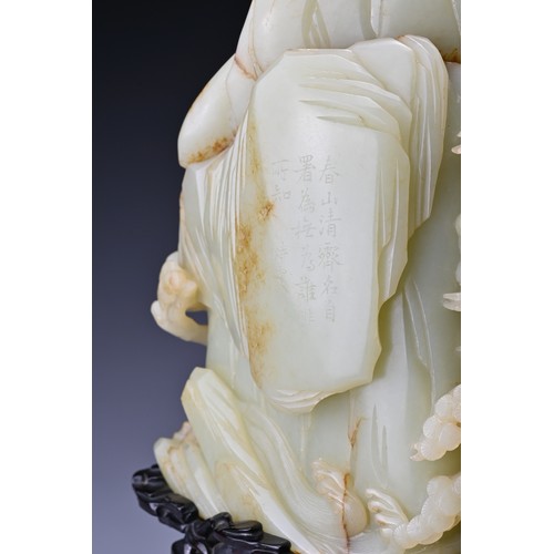 66 - A large Chinese celadon and russet jade boulder. Carved in high relief with two cranes and pine tree... 