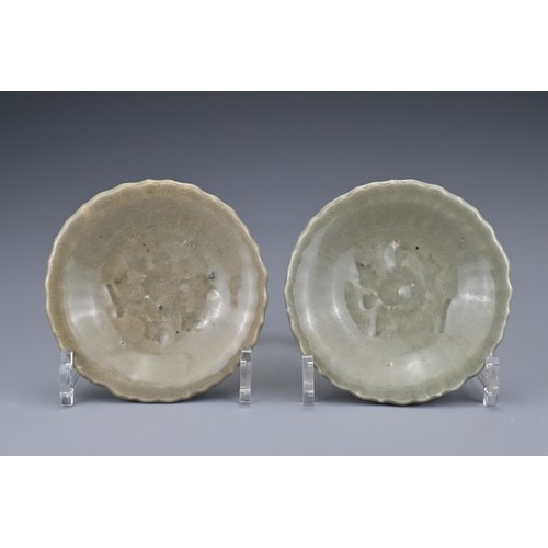 83 - A pair of Chinese Yuan/Ming dynasty Longquan celadon dishes. Lobbed with impressed floral spray to t... 