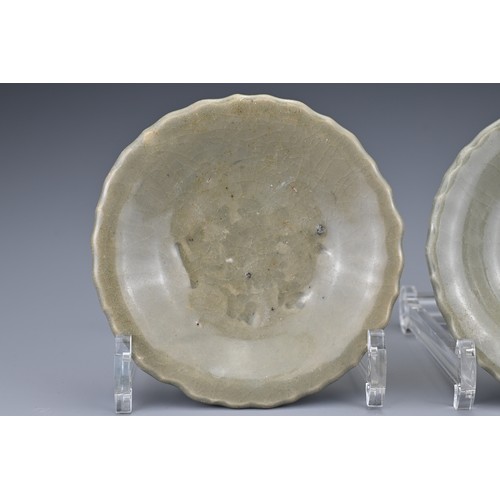 83 - A pair of Chinese Yuan/Ming dynasty Longquan celadon dishes. Lobbed with impressed floral spray to t... 