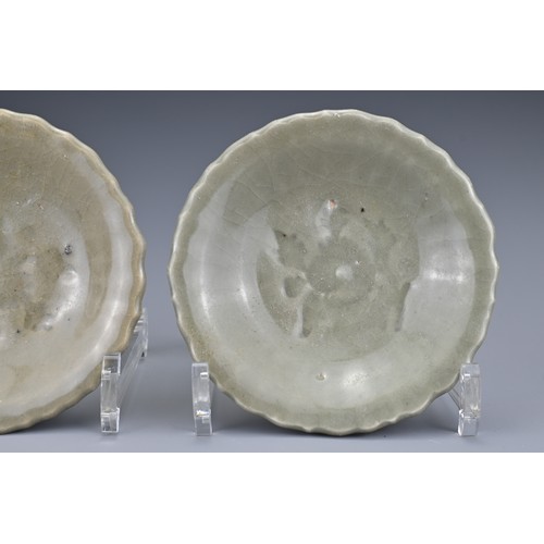 83 - A pair of Chinese Yuan/Ming dynasty Longquan celadon dishes. Lobbed with impressed floral spray to t... 