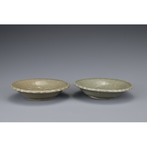 83 - A pair of Chinese Yuan/Ming dynasty Longquan celadon dishes. Lobbed with impressed floral spray to t... 