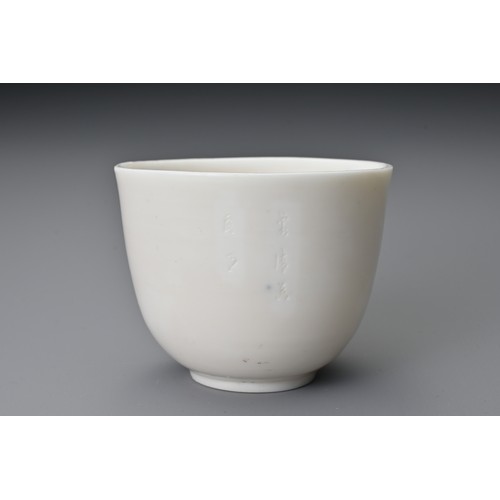 81 - A Chinese 17th century incised Dehua wine cup. The blanc de Chine cup raised on a shallow foot with ... 