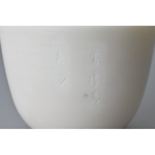 81 - A Chinese 17th century incised Dehua wine cup. The blanc de Chine cup raised on a shallow foot with ... 