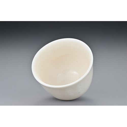 81 - A Chinese 17th century incised Dehua wine cup. The blanc de Chine cup raised on a shallow foot with ... 