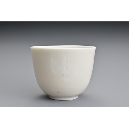 81 - A Chinese 17th century incised Dehua wine cup. The blanc de Chine cup raised on a shallow foot with ... 