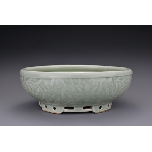 82 - A Chinese 18/19th century carved celadon-glazed porcelain censer. The exterior carved with floral sc... 