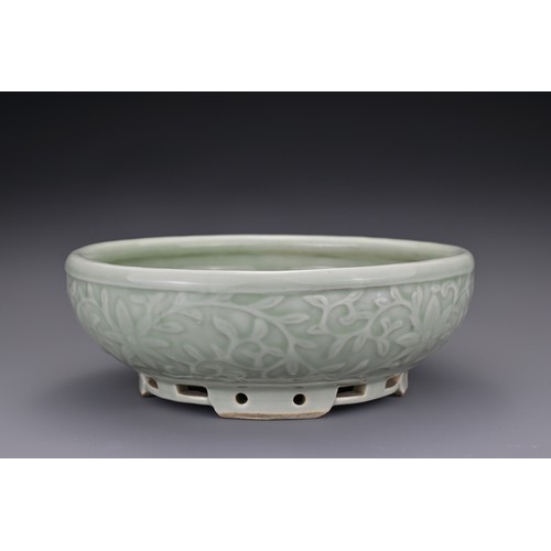 82 - A Chinese 18/19th century carved celadon-glazed porcelain censer. The exterior carved with floral sc... 