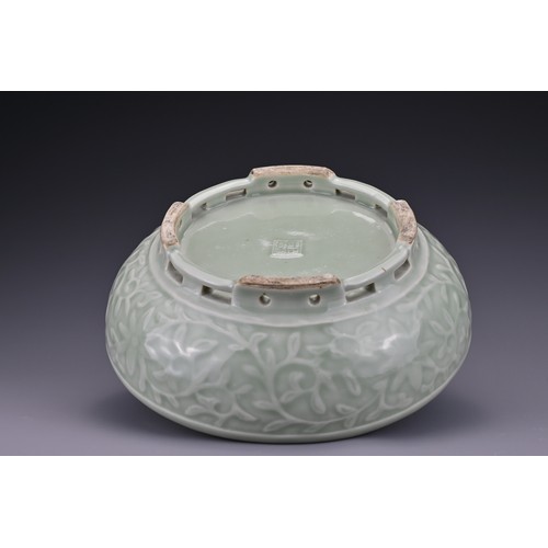 82 - A Chinese 18/19th century carved celadon-glazed porcelain censer. The exterior carved with floral sc... 