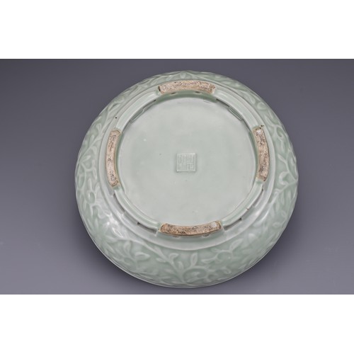 82 - A Chinese 18/19th century carved celadon-glazed porcelain censer. The exterior carved with floral sc... 