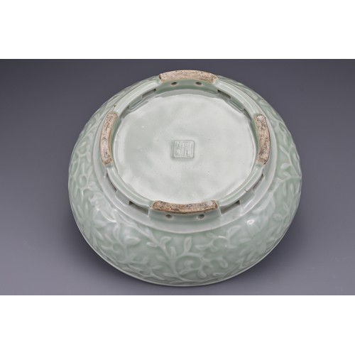 82 - A Chinese 18/19th century carved celadon-glazed porcelain censer. The exterior carved with floral sc... 