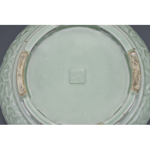 82 - A Chinese 18/19th century carved celadon-glazed porcelain censer. The exterior carved with floral sc... 