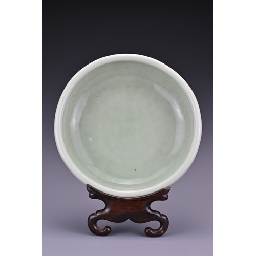 82 - A Chinese 18/19th century carved celadon-glazed porcelain censer. The exterior carved with floral sc... 