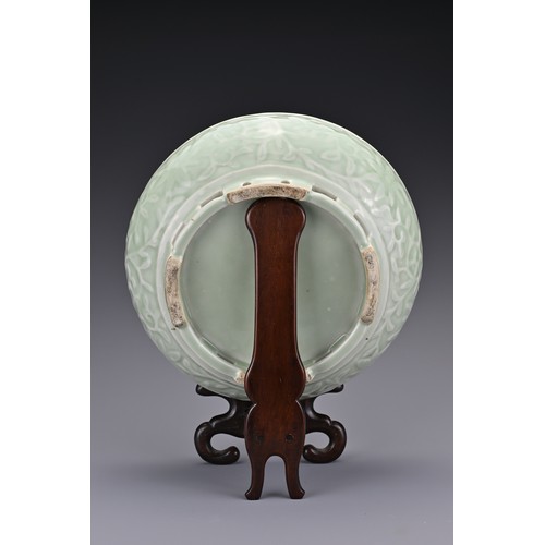 82 - A Chinese 18/19th century carved celadon-glazed porcelain censer. The exterior carved with floral sc... 