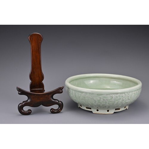 82 - A Chinese 18/19th century carved celadon-glazed porcelain censer. The exterior carved with floral sc... 