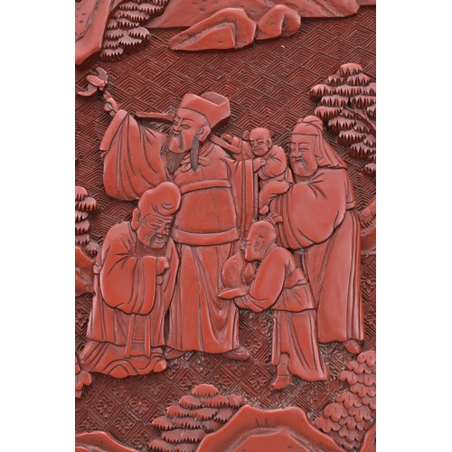 5 - A CHINESE CINNABAR LACQUER PANEL, 19TH CENTURY. Well carved in relief with scholar figures in a land... 