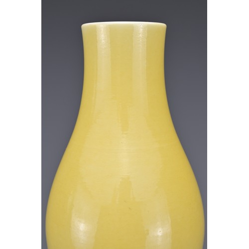 19 - A CHINESE OLIVE-FORM VASE, 18/19th CENTURY. Finely potted covered in a yellow glaze with six-charact... 