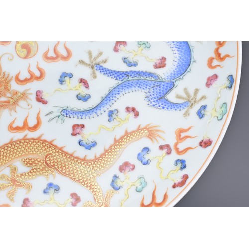 22 - A CHINESE PORCELAIN 'DRAGON' DISH, 19/20TH CENTURY. Decorated in polychrome enamels and gilt with th... 