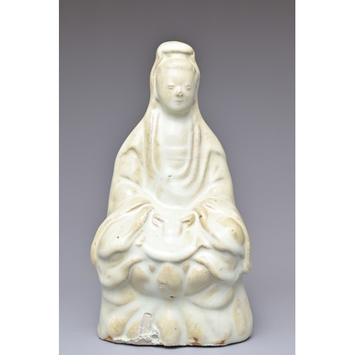 32 - A CHINESE CERAMIC FIGURE OF GUANYIN. The figure seated on a lotus base covered in a pale bluish whit... 