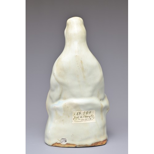 32 - A CHINESE CERAMIC FIGURE OF GUANYIN. The figure seated on a lotus base covered in a pale bluish whit... 