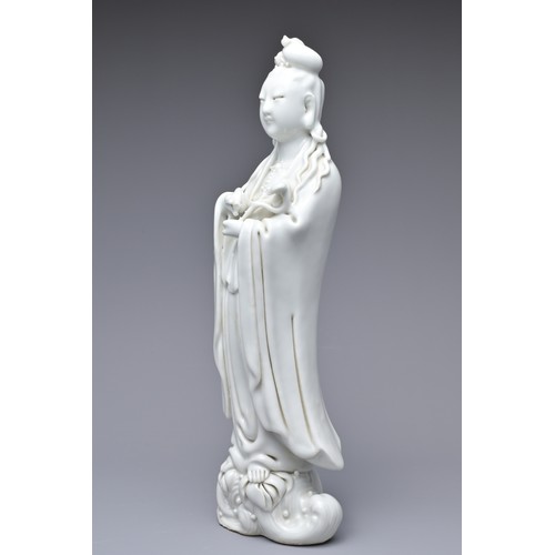 33 - A CHINESE BLANC DE CHINE PORCELAIN FIGURE OF GUANYIN, 18TH CENTURY. The figure standing on a lotus w... 