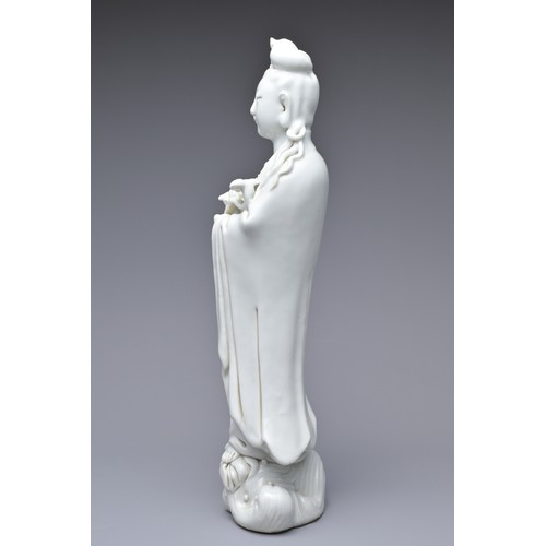 33 - A CHINESE BLANC DE CHINE PORCELAIN FIGURE OF GUANYIN, 18TH CENTURY. The figure standing on a lotus w... 