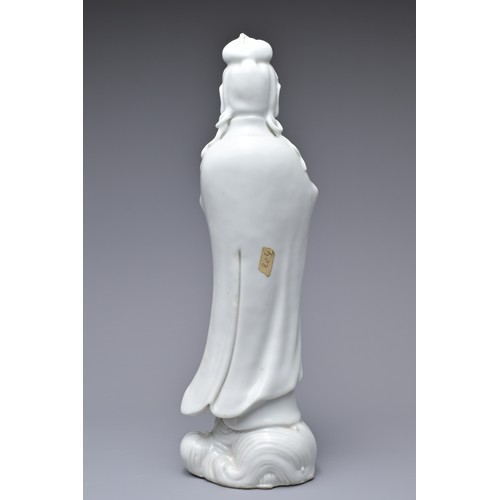 33 - A CHINESE BLANC DE CHINE PORCELAIN FIGURE OF GUANYIN, 18TH CENTURY. The figure standing on a lotus w... 