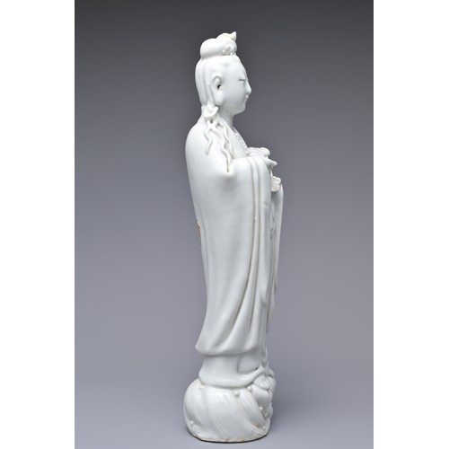 33 - A CHINESE BLANC DE CHINE PORCELAIN FIGURE OF GUANYIN, 18TH CENTURY. The figure standing on a lotus w... 