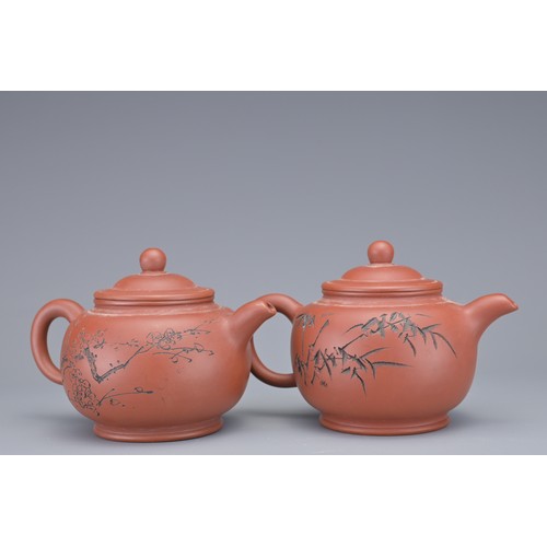 34 - A SET OF FOUR CHINESE YIXING POTTERY TEAPOTS. Each with incised calligraphy and foliage decoration. ... 