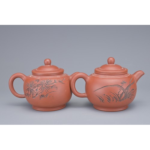 34 - A SET OF FOUR CHINESE YIXING POTTERY TEAPOTS. Each with incised calligraphy and foliage decoration. ... 