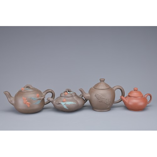 35 - A GROUP OF FOUR CHINESE YIXING POTTERY TEAPOTS. Each in various design. Four darker pottery teapots ... 