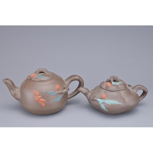 35 - A GROUP OF FOUR CHINESE YIXING POTTERY TEAPOTS. Each in various design. Four darker pottery teapots ... 