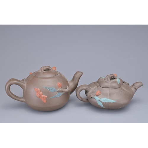 35 - A GROUP OF FOUR CHINESE YIXING POTTERY TEAPOTS. Each in various design. Four darker pottery teapots ... 