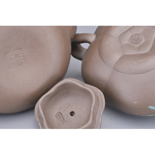 35 - A GROUP OF FOUR CHINESE YIXING POTTERY TEAPOTS. Each in various design. Four darker pottery teapots ... 