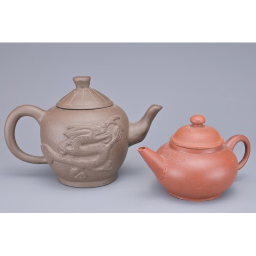 35 - A GROUP OF FOUR CHINESE YIXING POTTERY TEAPOTS. Each in various design. Four darker pottery teapots ... 