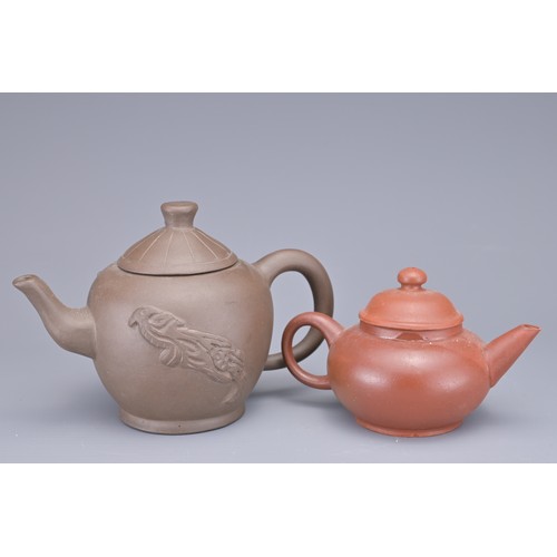 35 - A GROUP OF FOUR CHINESE YIXING POTTERY TEAPOTS. Each in various design. Four darker pottery teapots ... 