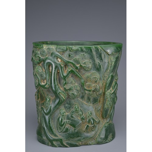 36 - A CHINESE GLASS BRUSH POT. Green colour raised decoration of scholar figures and pine trees with inc... 