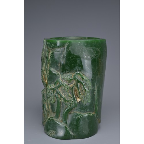 36 - A CHINESE GLASS BRUSH POT. Green colour raised decoration of scholar figures and pine trees with inc... 