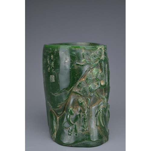 36 - A CHINESE GLASS BRUSH POT. Green colour raised decoration of scholar figures and pine trees with inc... 