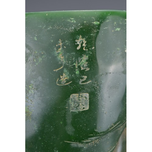 36 - A CHINESE GLASS BRUSH POT. Green colour raised decoration of scholar figures and pine trees with inc... 