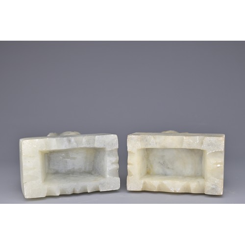 38 - PAIR OF CHINESE SOAPSTONE LION DOGS, 20TH CENTURY. Each on rectangular pedestals. 13cm height. (2)