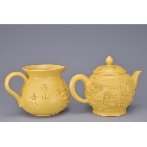 43 - A CHINESE VINTAGE YIXING POTTERY TEA SET, 20TH CENTURY. To include six cups, a teapot and jug in a y... 